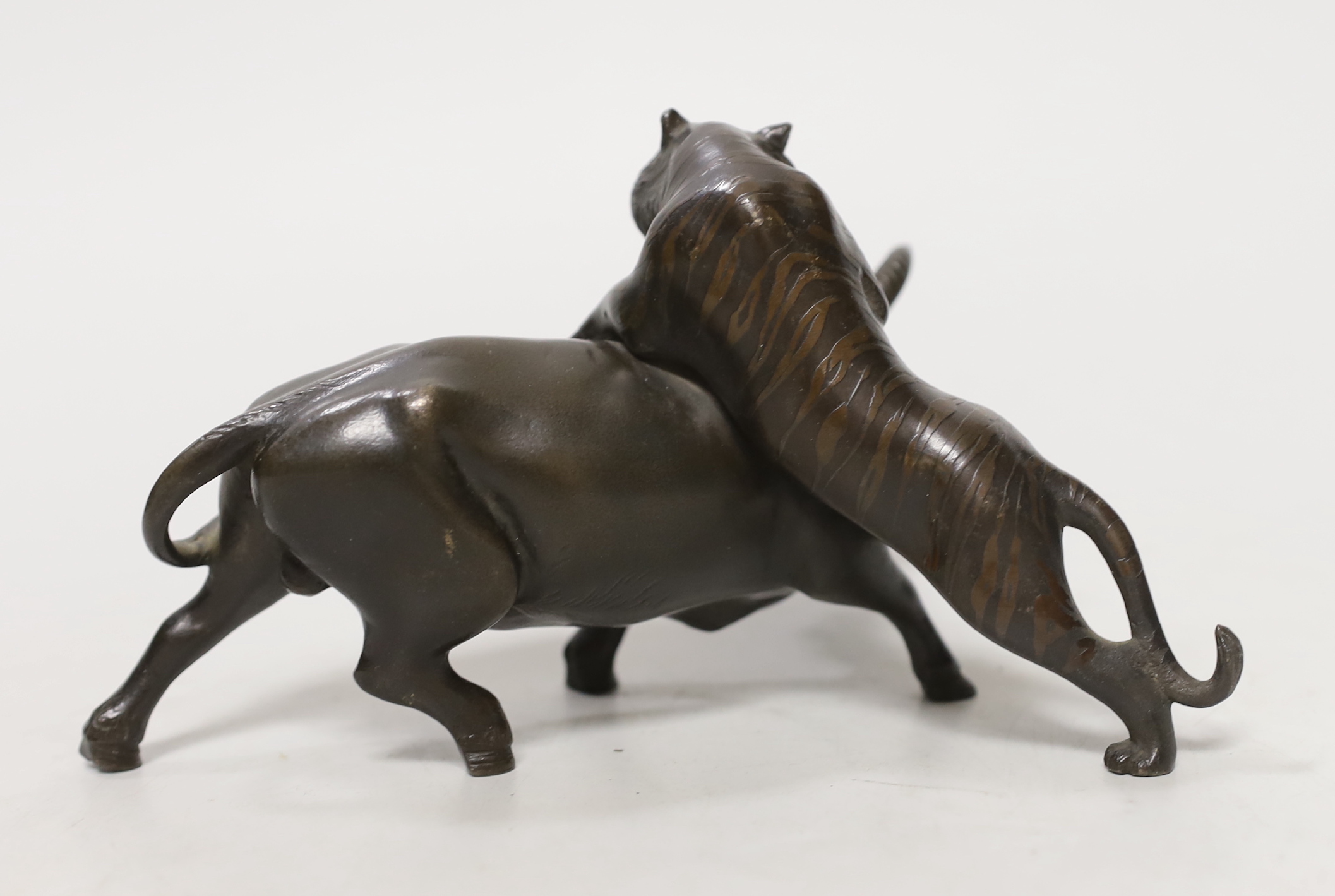 A Japanese bronze ‘tiger and ox group’, Meiji period, signed Seiya saku, 17cm